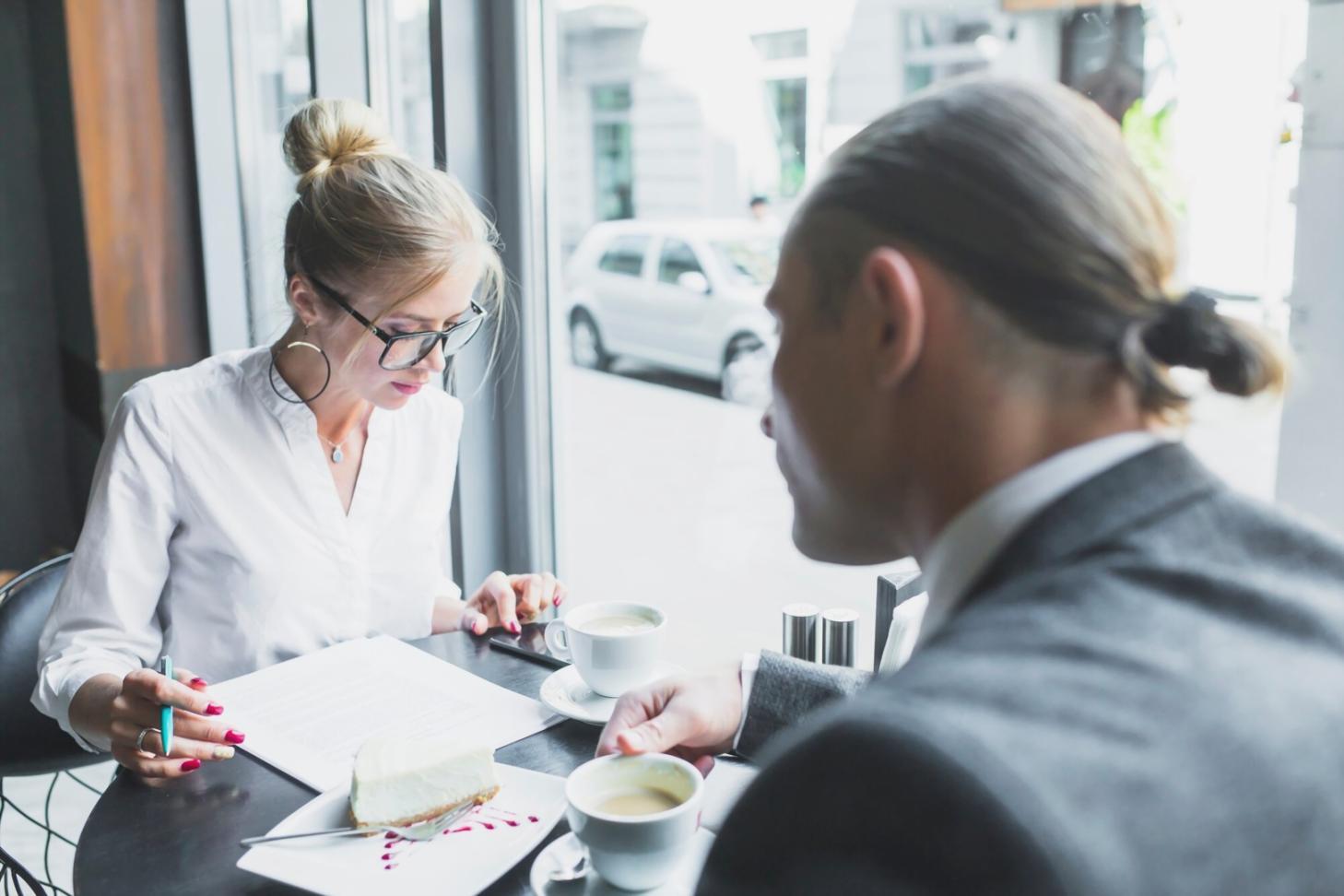 Financial analyst reviewing market data on multiple computer screens showing charts and economic indicators